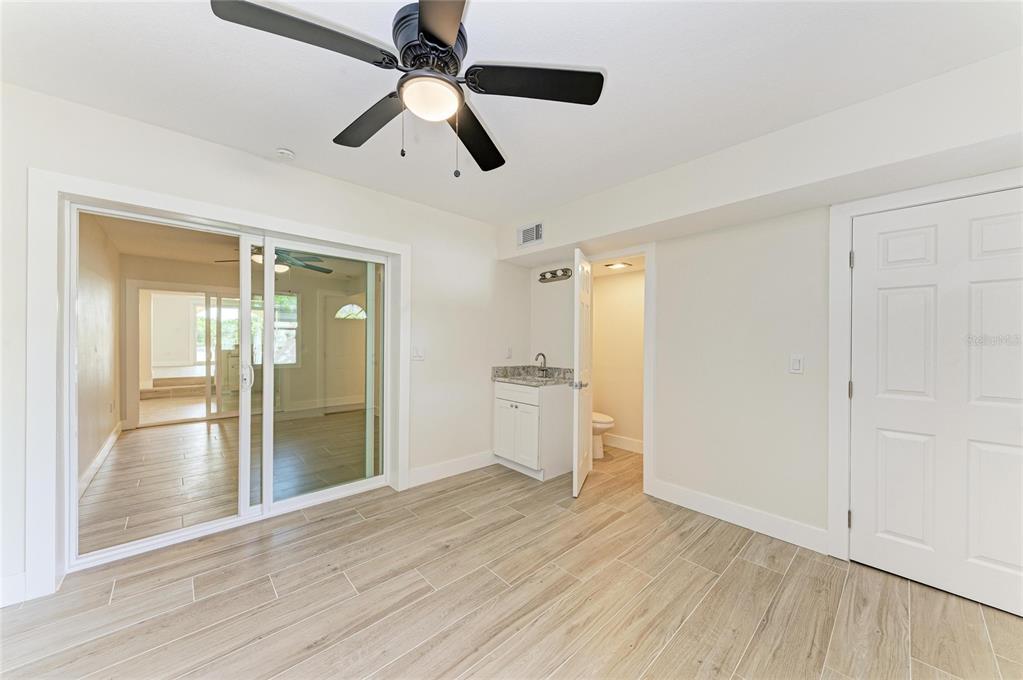 101 73rd Street, Unit 2 Holmes Beach, FL 34217 - Photo 32 of 54 a view of empty room with wooden floor and fan