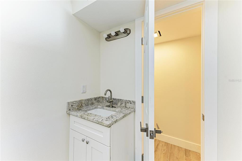 101 73rd Street, Unit 2 Holmes Beach, FL 34217 - Photo 33 of 54 a bathroom with a granite countertop sink and a mirror
