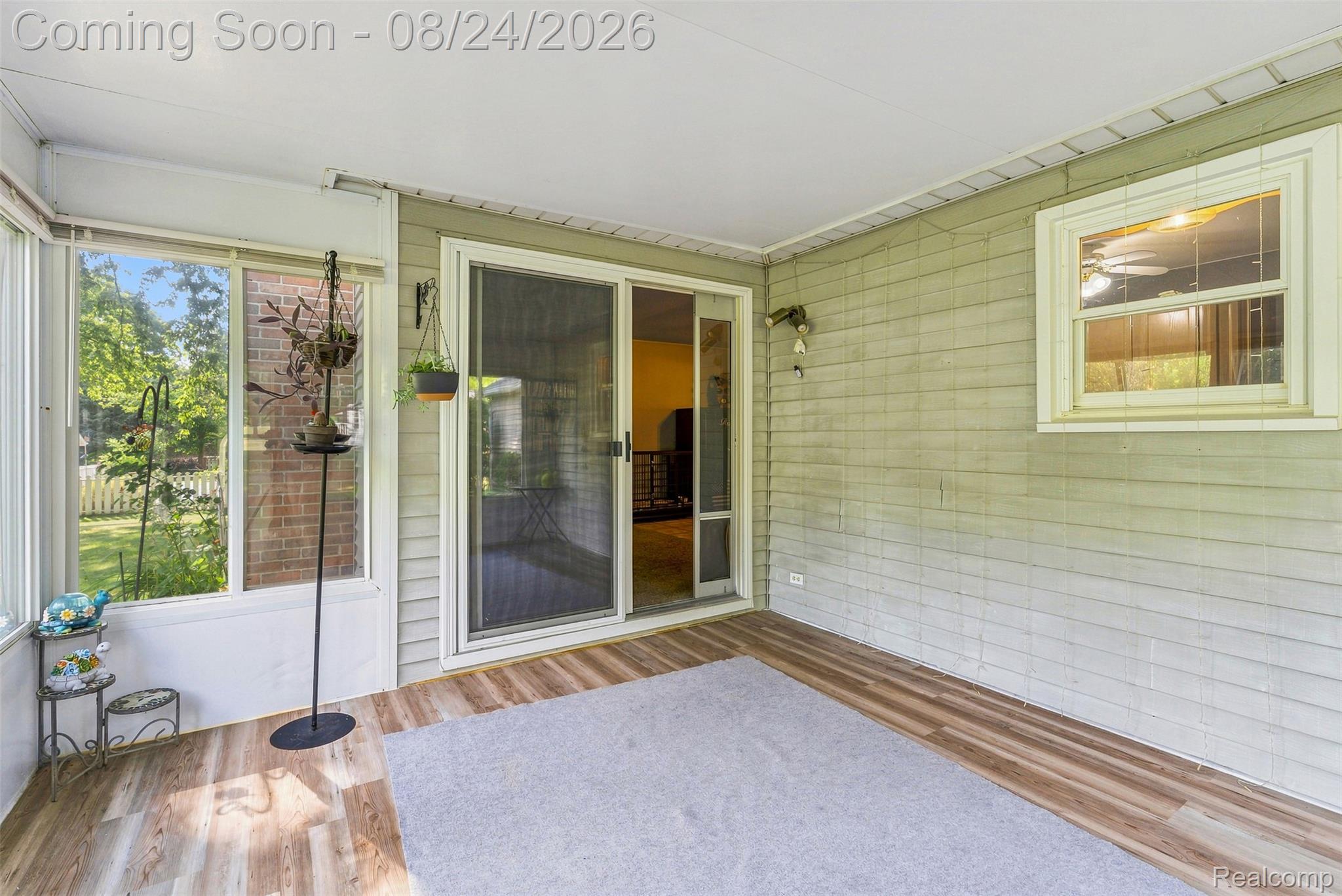 2310 Peppermill Road Lapeer, MI 48446 - Photo 24 of 35 Enclosed sunroom with wood-finish flooring, sliding glass door, and multiple windows