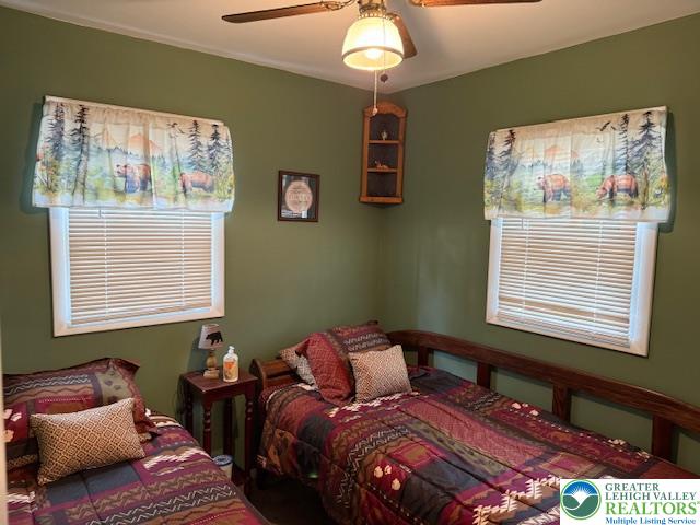 192 Cartwright Road Blakeslee, PA 18610 - Photo 14 of 20 a bedroom with a bed lamp and a window