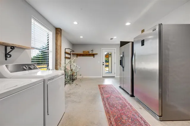 a kitchen with stainless steel appliances granite countertop a refrigerator and a sink