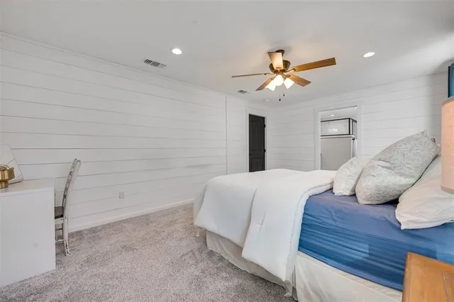 a bedroom with a bed and a ceiling fan