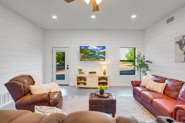 a living room with furniture a couch and a flat screen tv