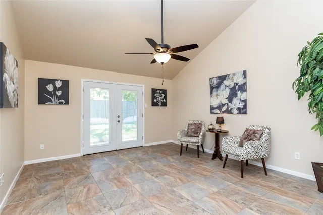a view of an empty room with a window and furniture