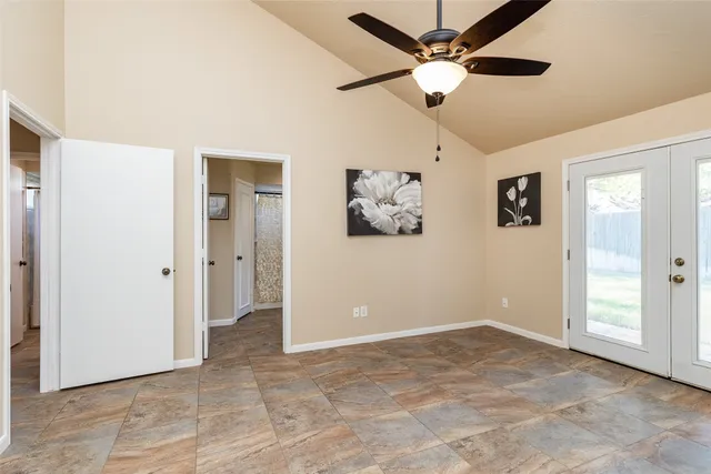 a view of a livingroom with a ceiling fan and window