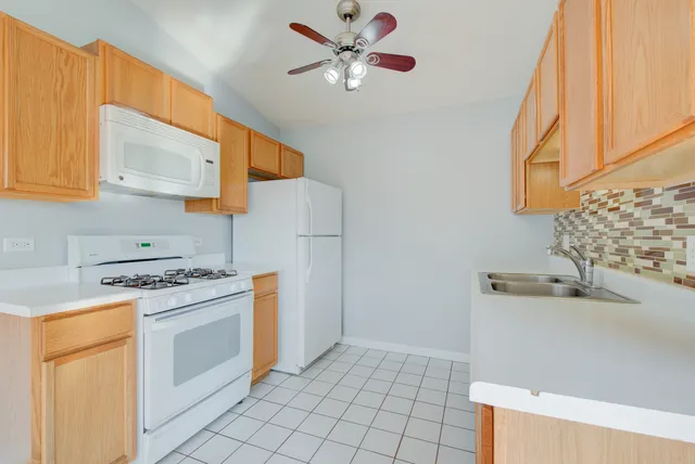 a kitchen with a stove a sink and a refrigerator