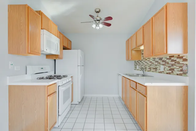 a kitchen with a stove a sink and a refrigerator
