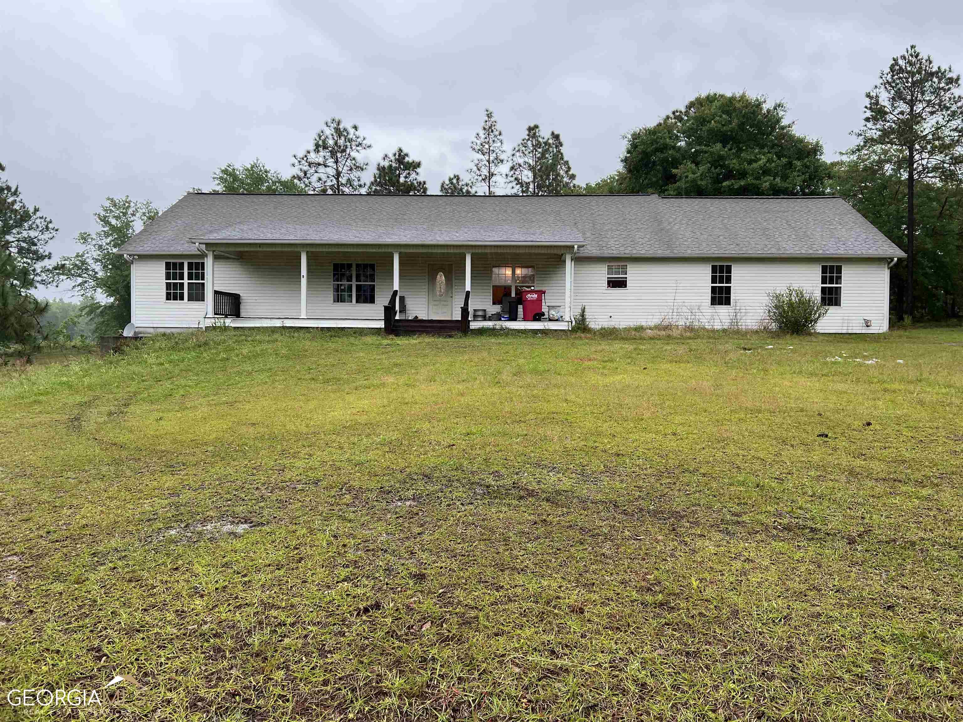 7658 Thompson Pond Road Tarrytown, GA 30470 - Photo 1 of 1 a front view of a house with garden