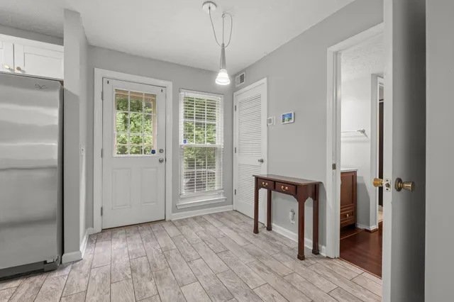 a view of room with furniture and wooden floor