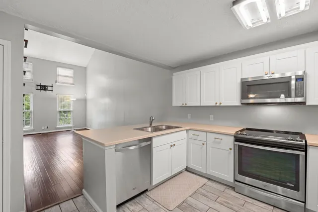 a kitchen with a sink stove and microwave
