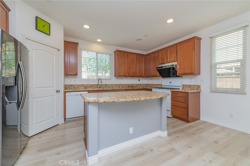 9361 Culinary Rancho Cucamonga, CA 91730 - Photo 13 of 45 a kitchen with a refrigerator and a stove top oven