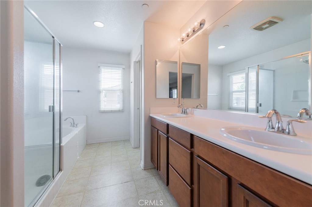 9361 Culinary Rancho Cucamonga, CA 91730 - Photo 22 of 45 a bathroom with a double vanity sink mirror and shower