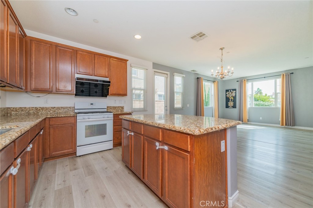 9361 Culinary Rancho Cucamonga, CA 91730 - Photo 23 of 45 a kitchen with granite countertop cabinets stainless steel appliances and wooden floor