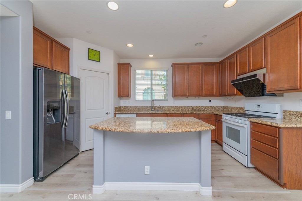 9361 Culinary Rancho Cucamonga, CA 91730 - Photo 26 of 45 a kitchen with stainless steel appliances granite countertop a stove a refrigerator and a sink