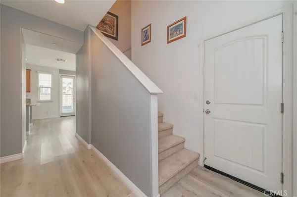 a view of a hallway with wooden floor and entryway