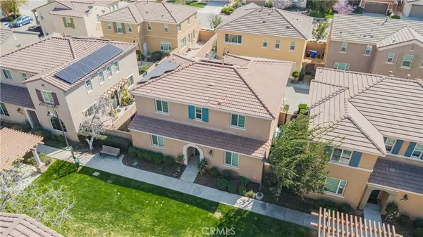 an aerial view of a house with a yard