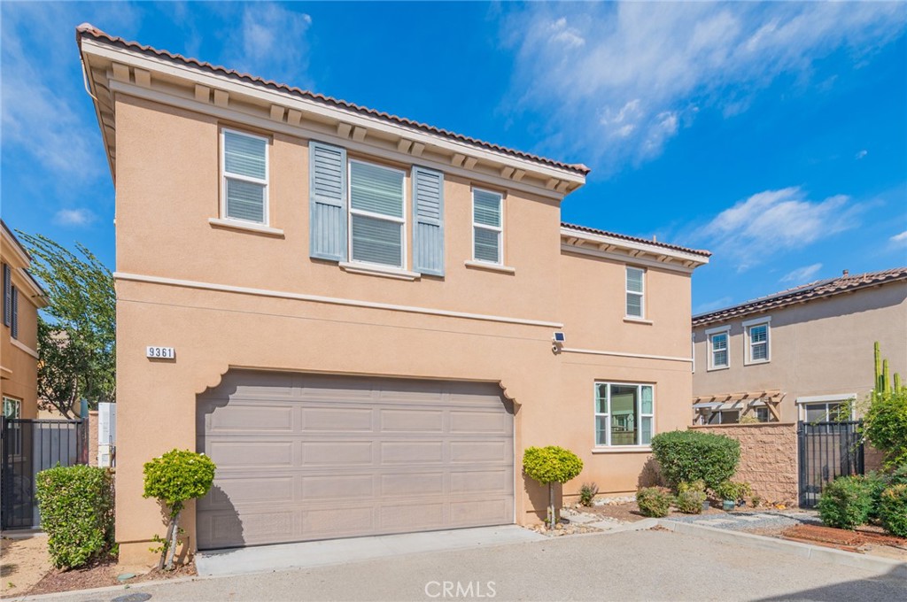 9361 Culinary Rancho Cucamonga, CA 91730 - Photo 4 of 45 a front view of a house with a yard and garage