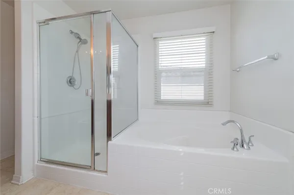 a white bath tub sitting next to a shower