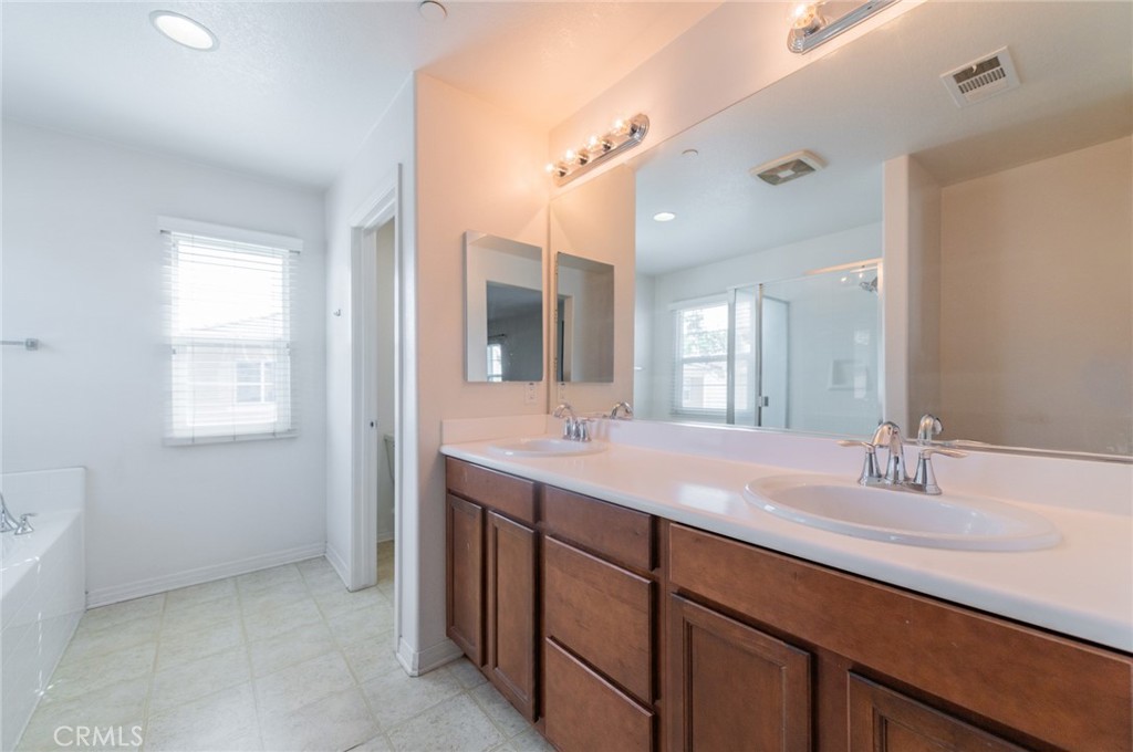 9361 Culinary Rancho Cucamonga, CA 91730 - Photo 8 of 45 a bathroom with a double vanity sink and a mirror