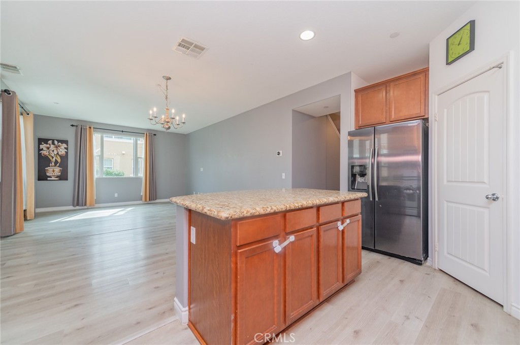 9361 Culinary Rancho Cucamonga, CA 91730 - Photo 8 of 45 a kitchen with stainless steel appliances granite countertop a refrigerator and a wooden floors