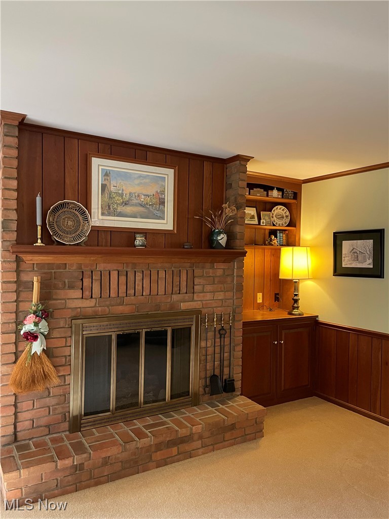 730 Phillips Road Northeast Massillon, OH 44646 - Photo 15 of 27 Living room with brick wall, a brick fireplace, and light carpet