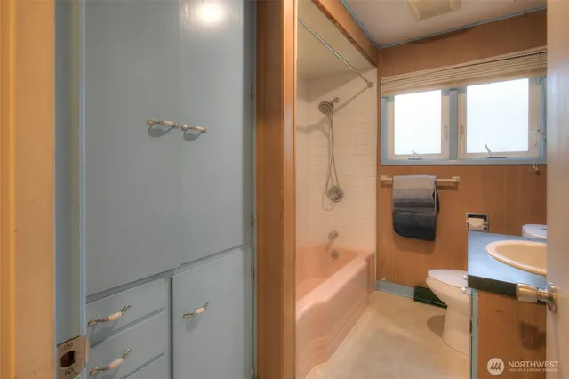 a bathroom with a sink a toilet and mirror