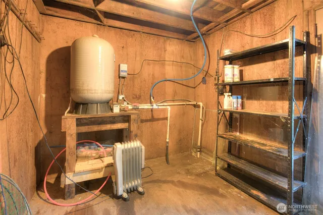 a room with water heater and wooden floor