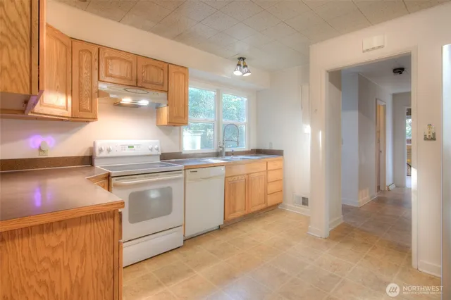 a kitchen with a refrigerator and a stove
