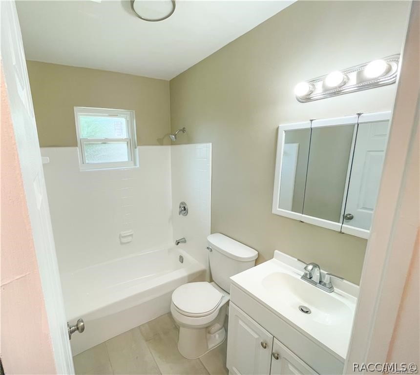 405 Copperfield Road Spring Hill, FL 34606 - Photo 17 of 25 a bathroom with a sink a toilet and shower
