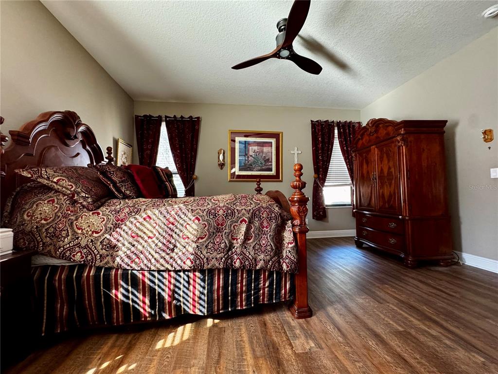 12419 Betony Court New Port Richey, FL 34654 - Photo 11 of 24 a bedroom with a bed and wooden floor