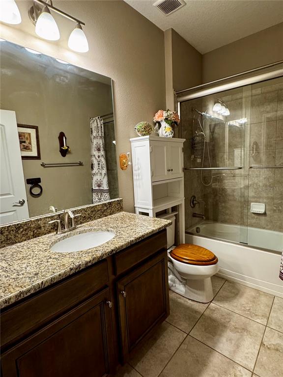 12419 Betony Court New Port Richey, FL 34654 - Photo 17 of 24 a bathroom with a granite countertop sink toilet and a mirror