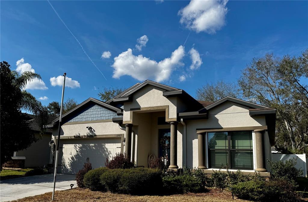 12419 Betony Court New Port Richey, FL 34654 - Photo 2 of 24 a front view of a house with a yard