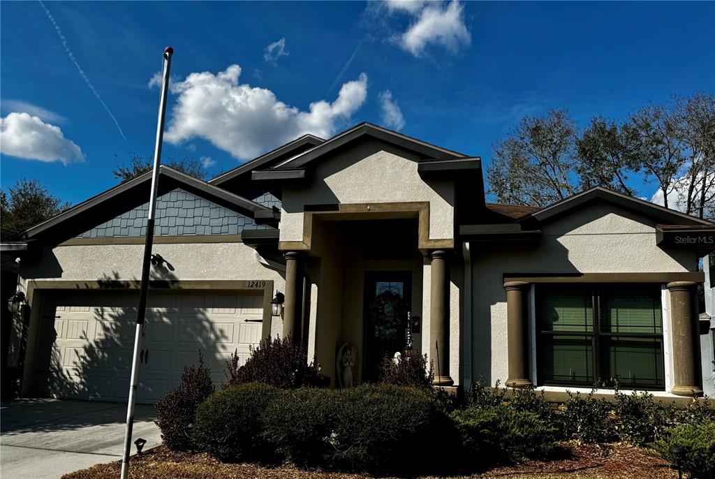 12419 Betony Court New Port Richey, FL 34654 - Photo 3 of 24 a front view of a house with a garden