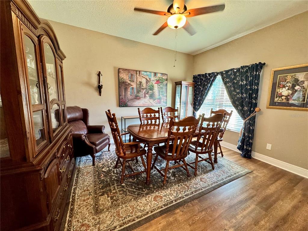 12419 Betony Court New Port Richey, FL 34654 - Photo 10 of 24 a view of a dining room with furniture window and wooden floor