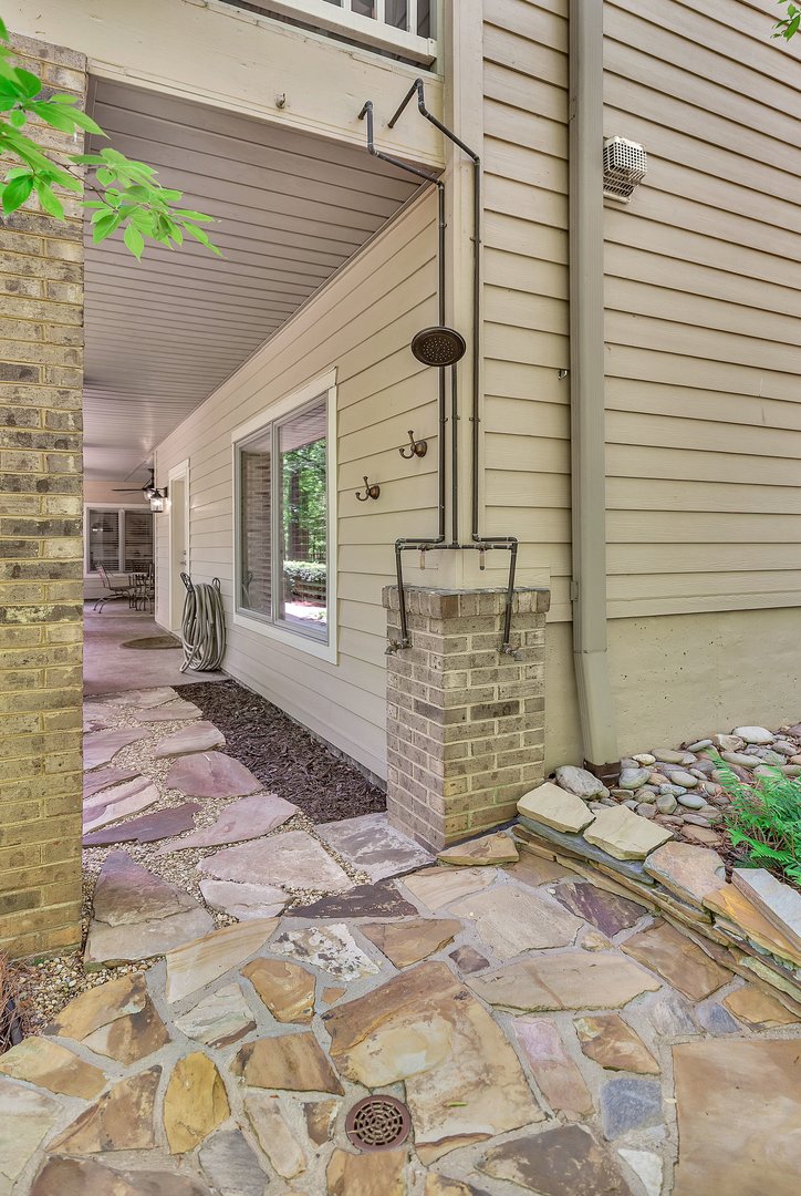 402 Boaters Row Fair Play, SC 29643 - Photo 35 of 50 An inviting outdoor shower and flagstone patio create a perfect space for al fresco relaxation.