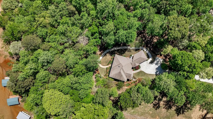 402 Boaters Row Fair Play, SC 29643 - Photo 44 of 50 This lush, expansive property features a grand residence nestled among abundant trees, offering serene privacy.