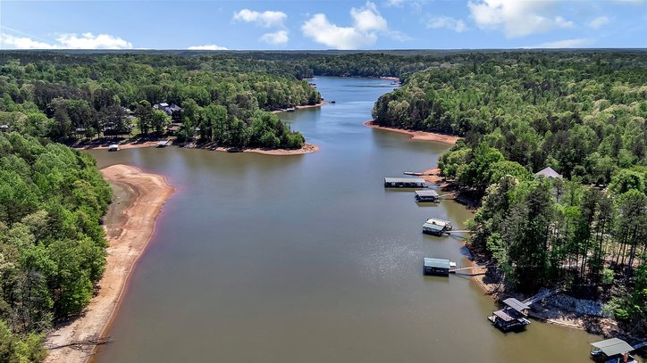 402 Boaters Row Fair Play, SC 29643 - Photo 45 of 50 This aerial view showcases a picturesque waterfront property with lush greenery and private boat docks.