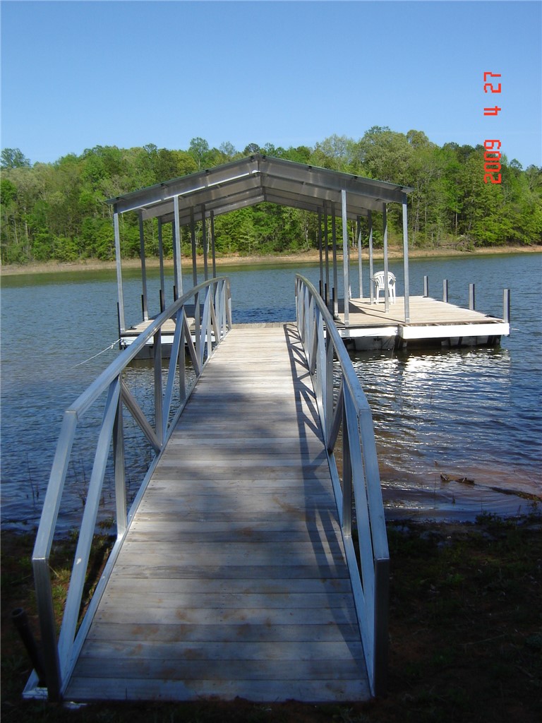 402 Boaters Row Fair Play, SC 29643 - Photo 47 of 50 This scenic waterfront property offers a private boat dock with a covered slip, perfect for aquatic adventures.