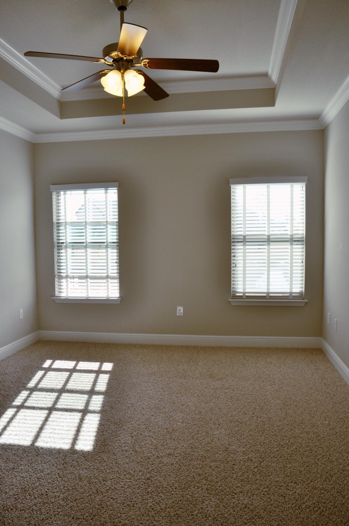 493 Cocobolo Drive Santa Rosa Beach, FL 32459 - Photo 13 of 18 en empty room with windows and chandelier fan