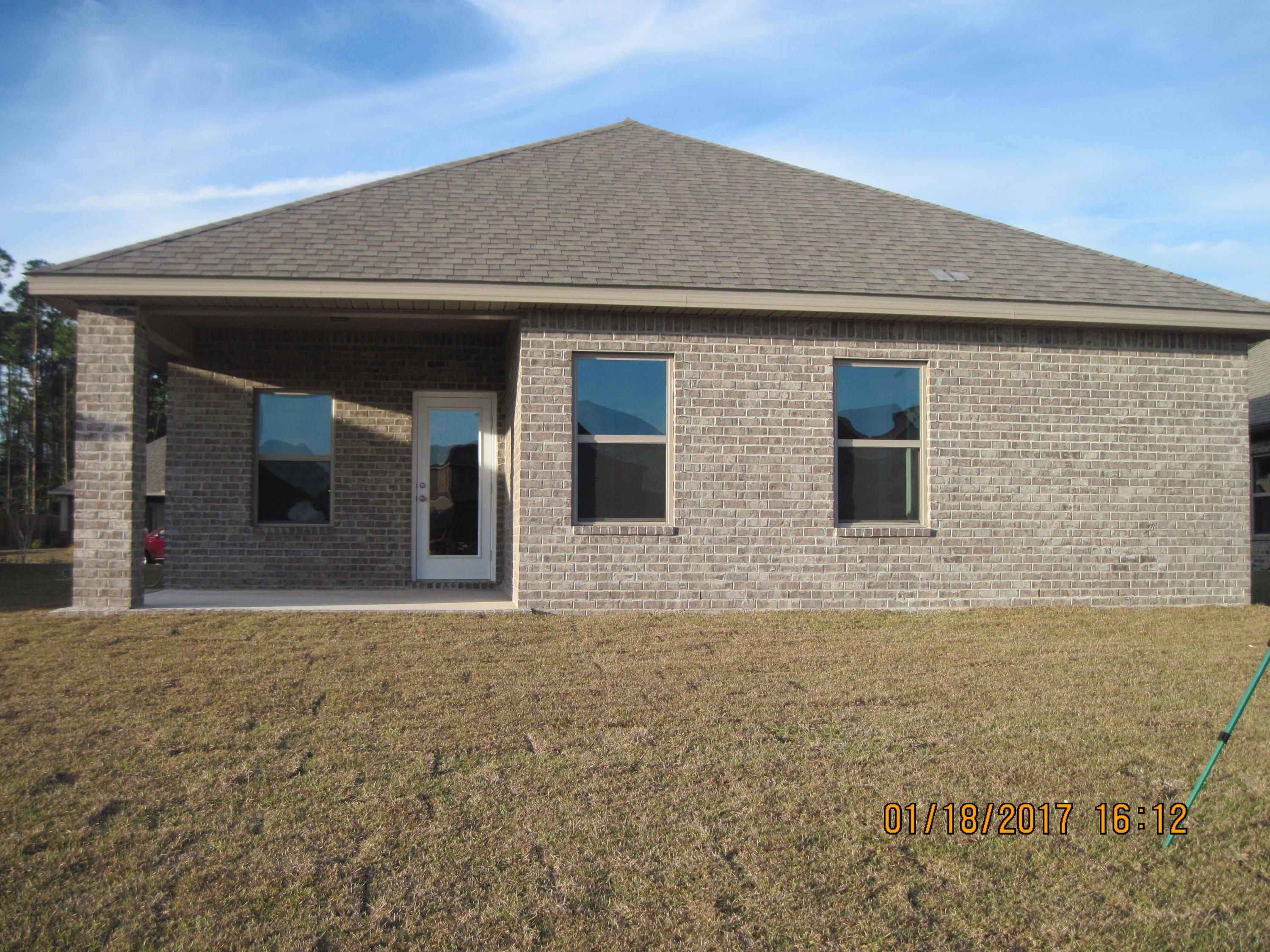 493 Cocobolo Drive Santa Rosa Beach, FL 32459 - Photo 18 of 18 a front view of a house with large windows
