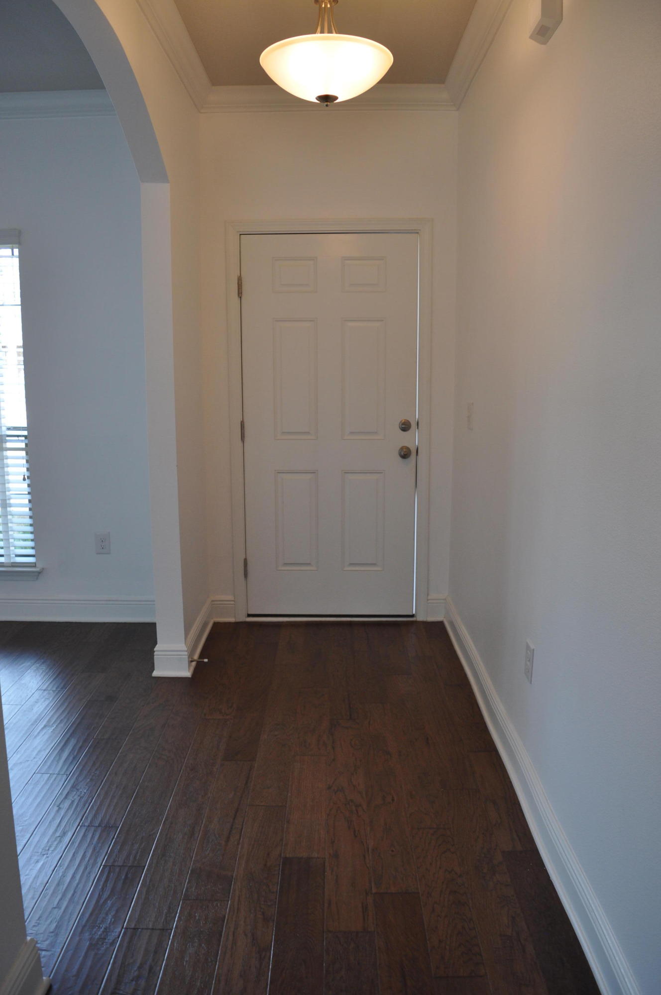 493 Cocobolo Drive Santa Rosa Beach, FL 32459 - Photo 3 of 18 an empty room with wooden floor and windows