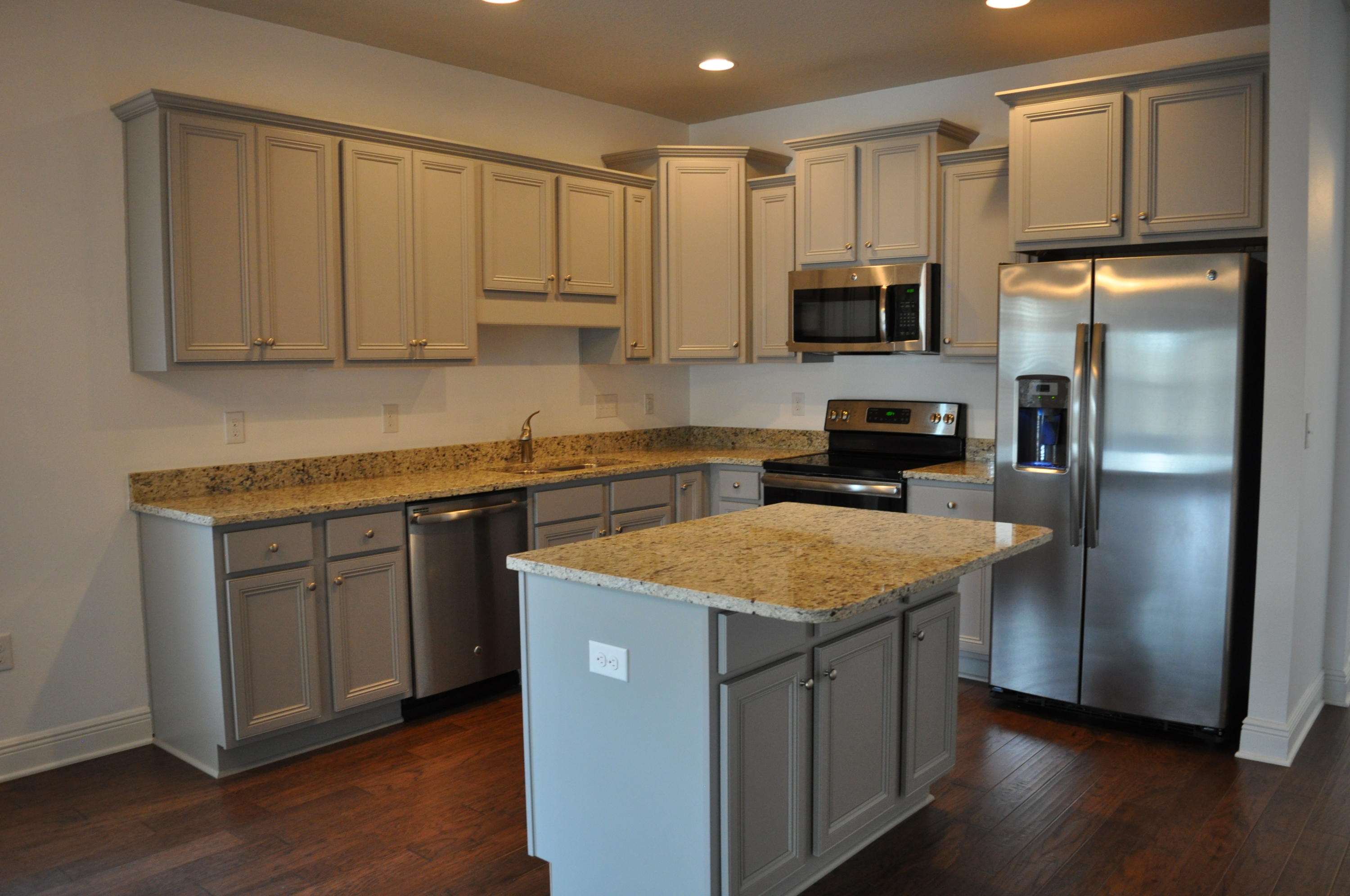 493 Cocobolo Drive Santa Rosa Beach, FL 32459 - Photo 5 of 18 a kitchen with stainless steel appliances granite countertop a refrigerator a sink dishwasher and white cabinets with wooden floor