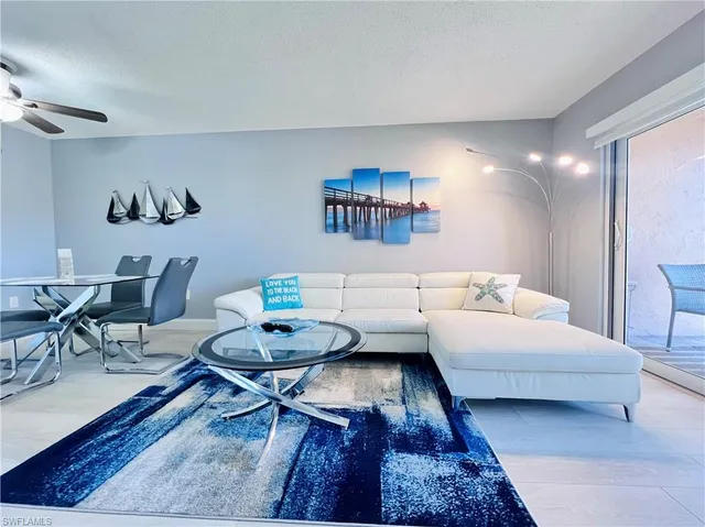 a living room with furniture and a rug