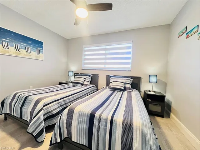 a bedroom with two beds and a chandelier