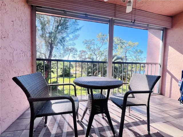 a view of a chairs and table in patio