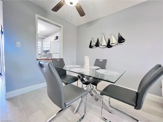 a view of a dining room with furniture and chandelier