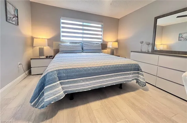 a bedroom with a bed and a mirror