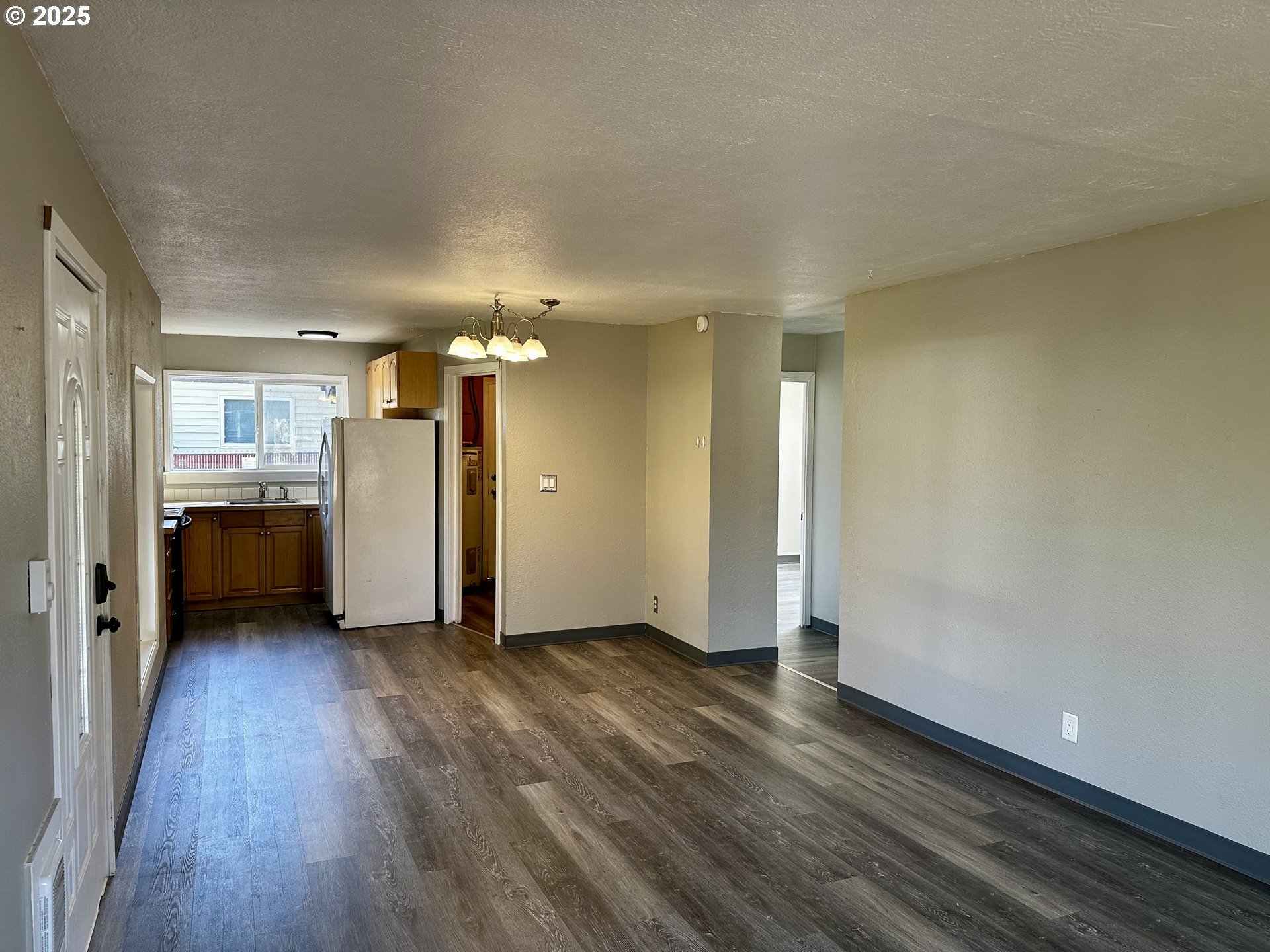 1733 I Street Springfield, OR 97477 - Photo 14 of 28 a view of a kitchen with wooden floor and a refrigerator