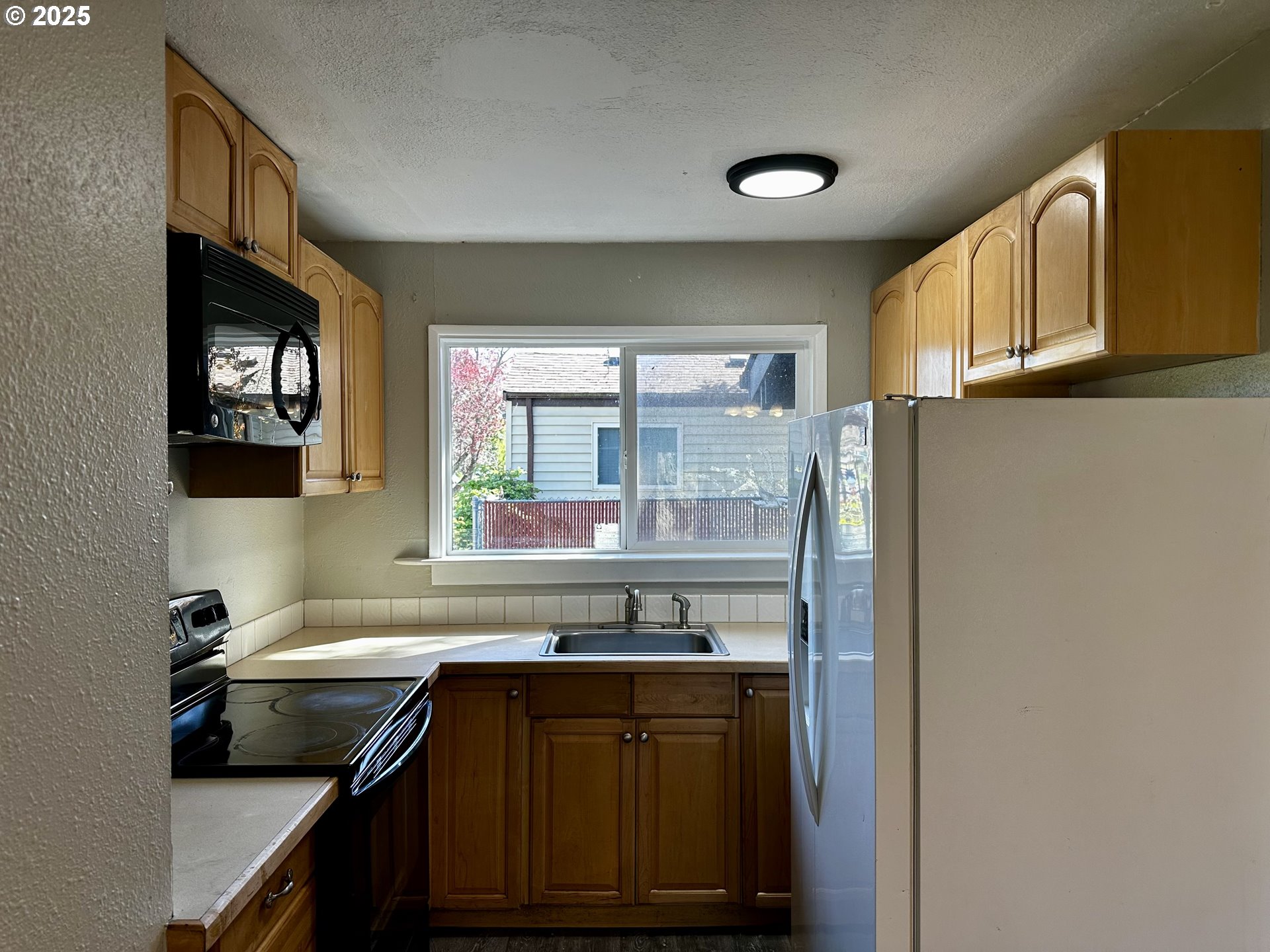 1733 I Street Springfield, OR 97477 - Photo 16 of 28 a kitchen with a sink cabinets and window