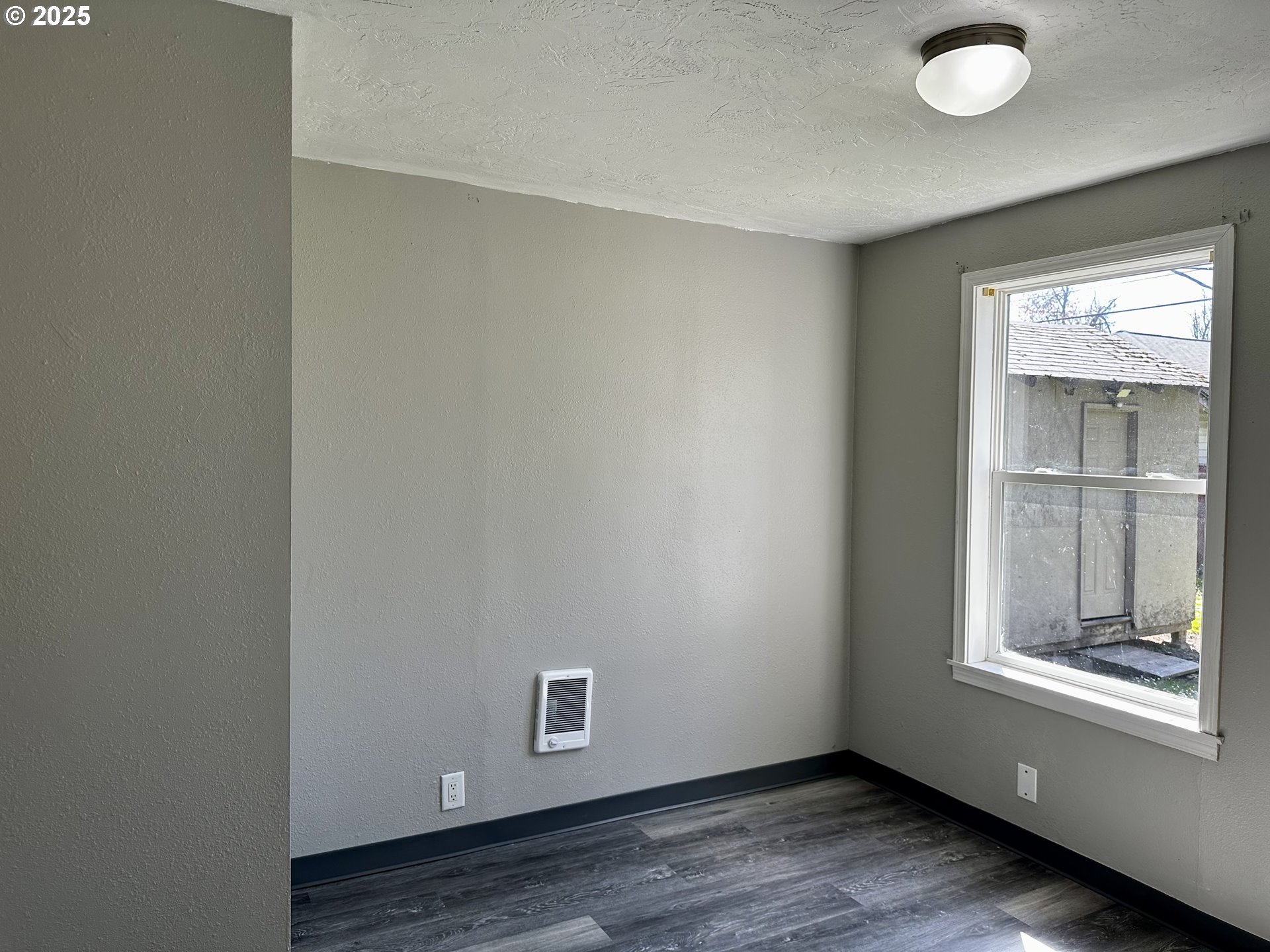1733 I Street Springfield, OR 97477 - Photo 21 of 28 a view of an empty room with wooden floor and a window